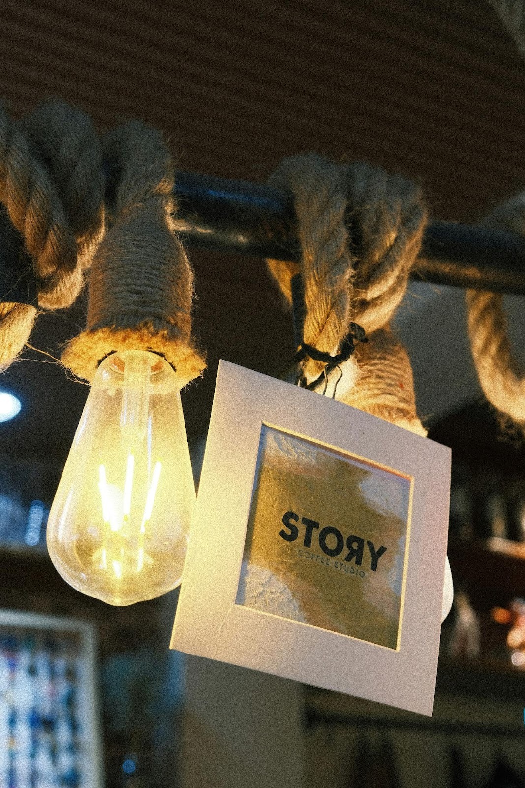 Close-up of a hanging lightbulb with a "Story" tag, symbolizing the importance of brand storytelling skills for marketers.