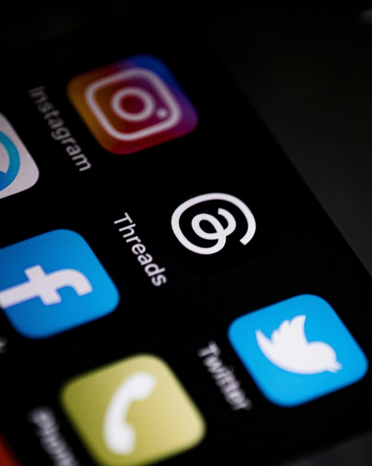 Smartphone screen displaying social media icons like Instagram and Facebook, essential for social media management services.