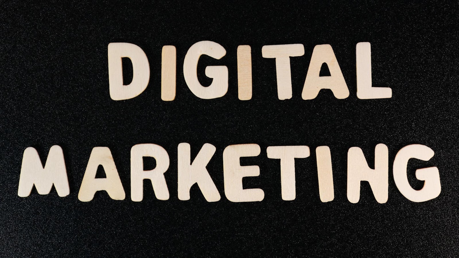 Wooden letters spelling out Digital Marketing, emphasizing the shift to online strategies for business success.