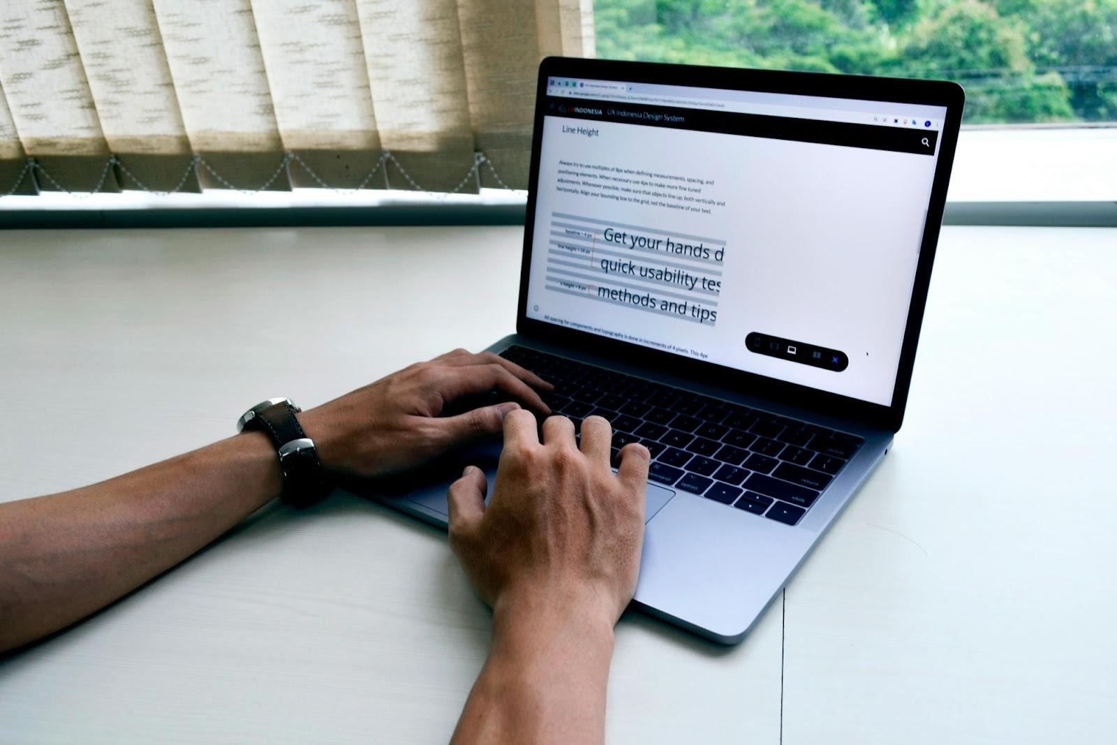 Web designer adjusting typography on a laptop, illustrating the technical web design needed for a high-performing dental site.