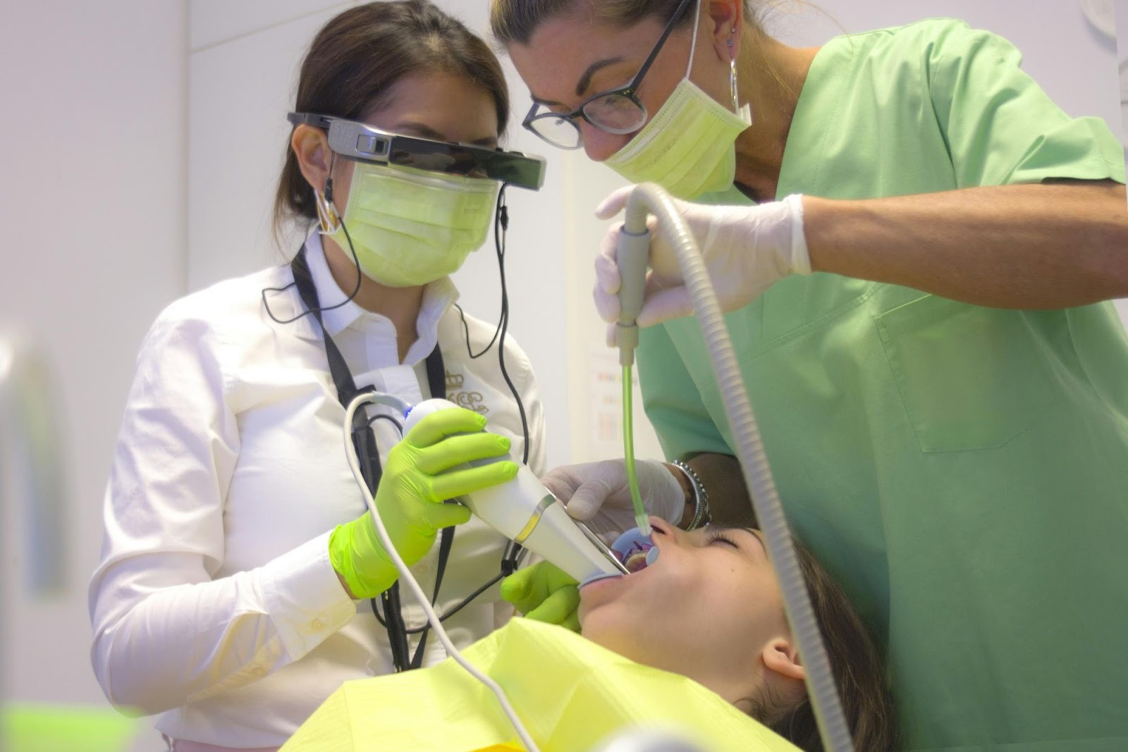 Dentist using high-tech smart glasses during treatment, showcasing advanced technology as a key differentiator in dental marketing.