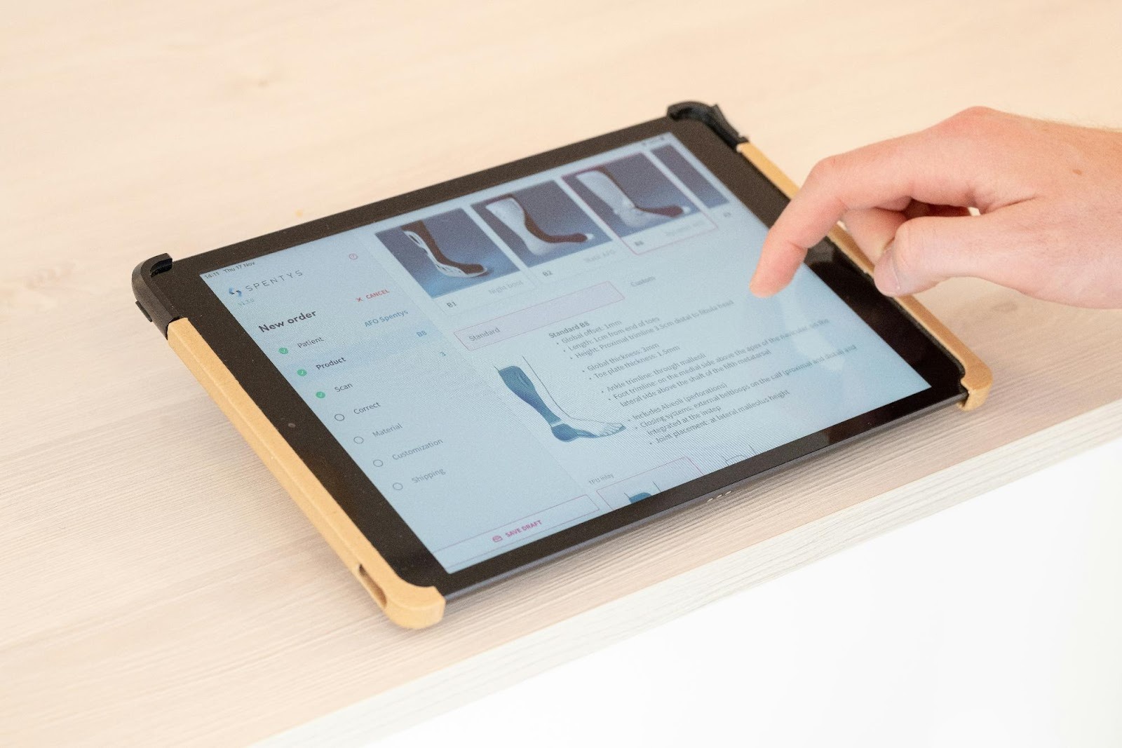 Hand using a tablet for digital scanning, highlighting the advanced technology that sets a modern dental practice apart.